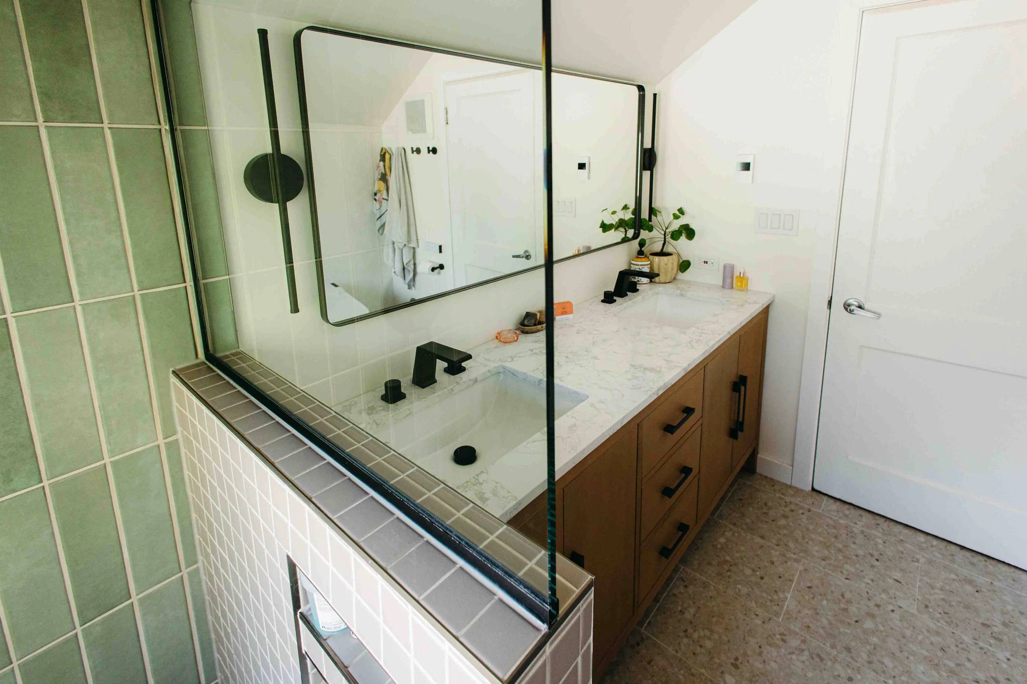 Saskatoon Washroom reno showcase image featuring shower glass, tile, and vanity
