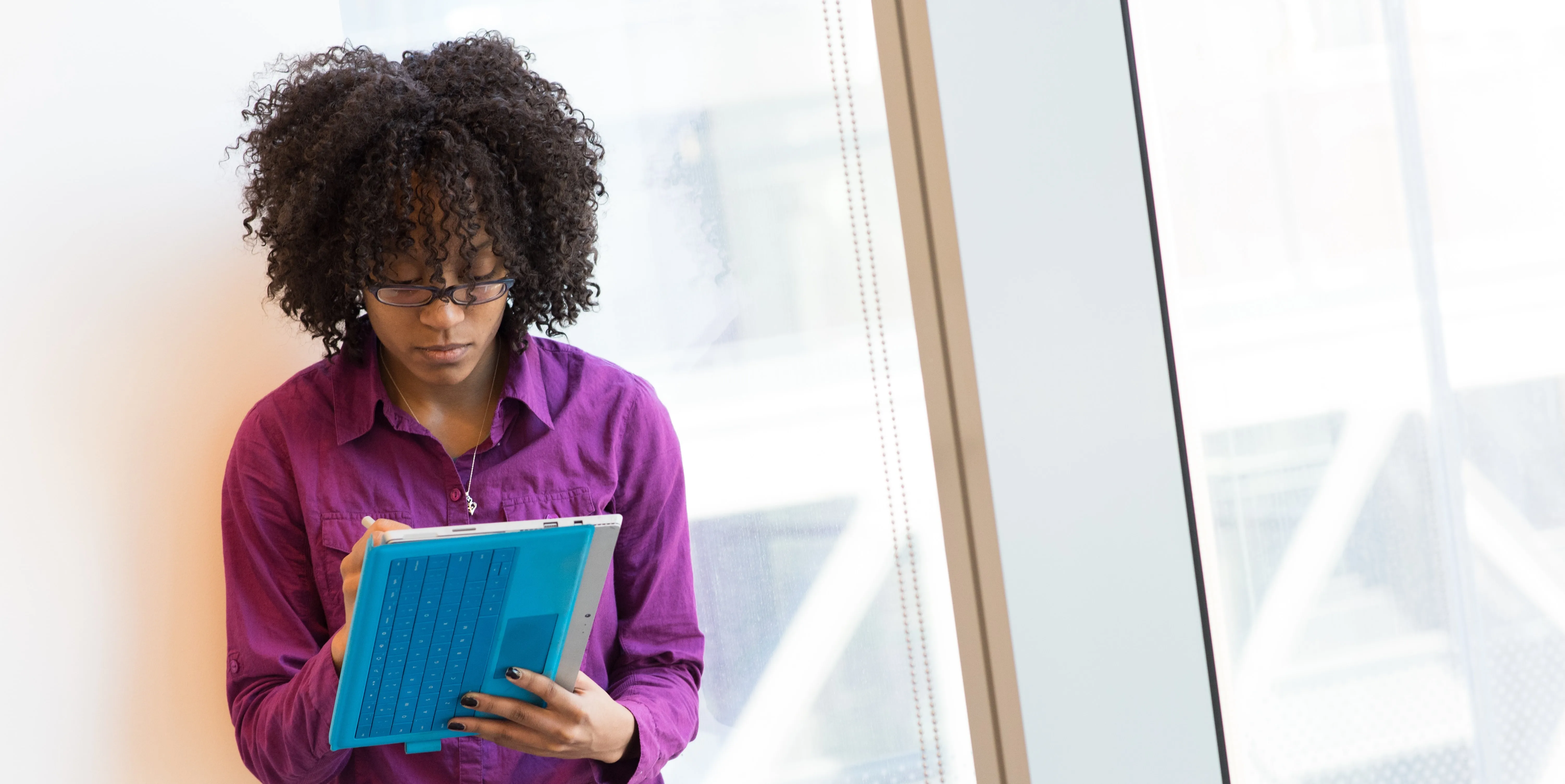 Woman in purple shirt learning how to manage remote team