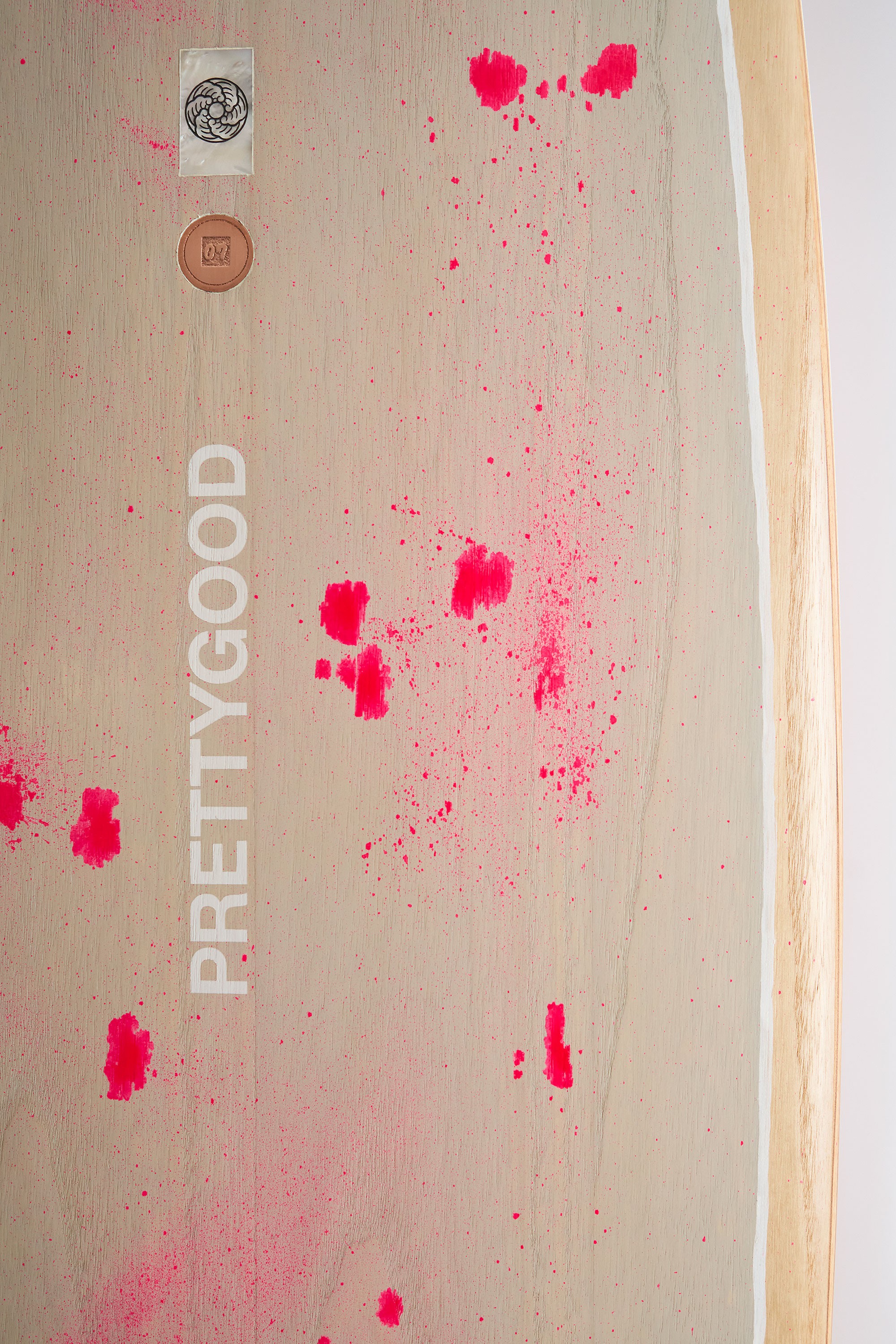 Hand painted logo on wooden surfboard