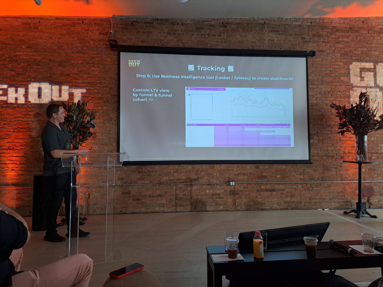 Two colleagues smiling while working together on a laptop.