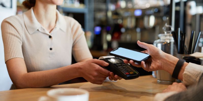 A Malaysian F&B customer paying for her food