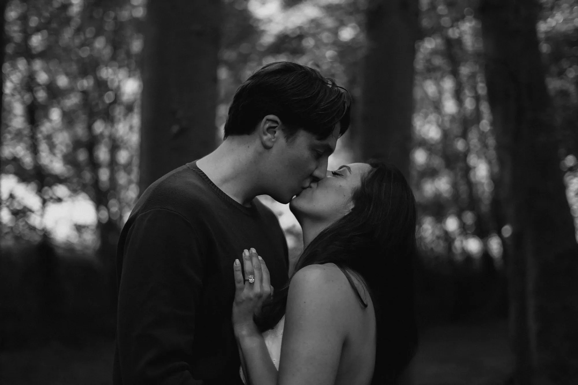 Connor and Cherine sharing a playful moment in the woods
