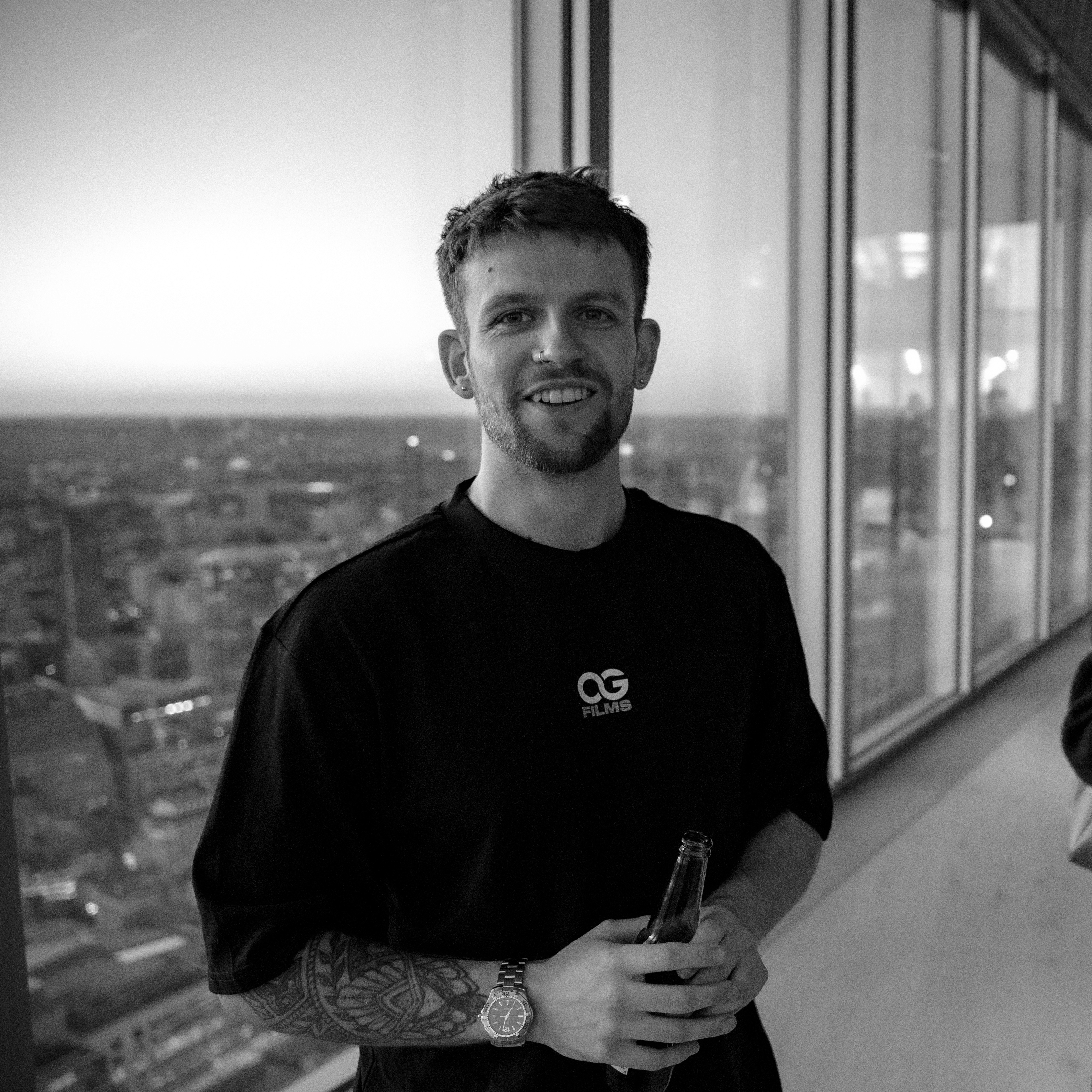 Profile portrait of a man in a white shirt against a light background