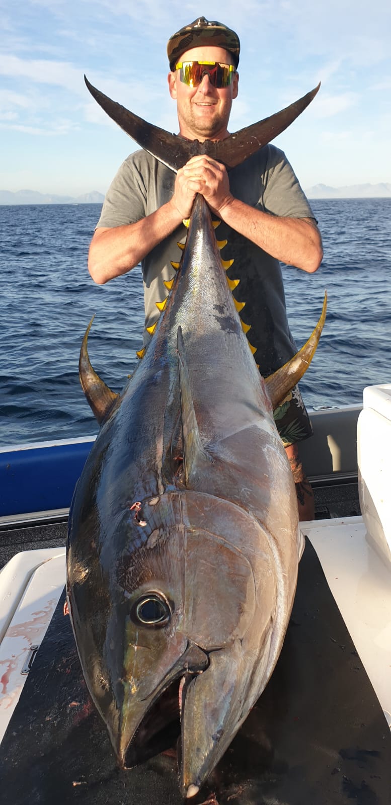 Fishermen celebrating a successful catch on a Salt Safari charter.