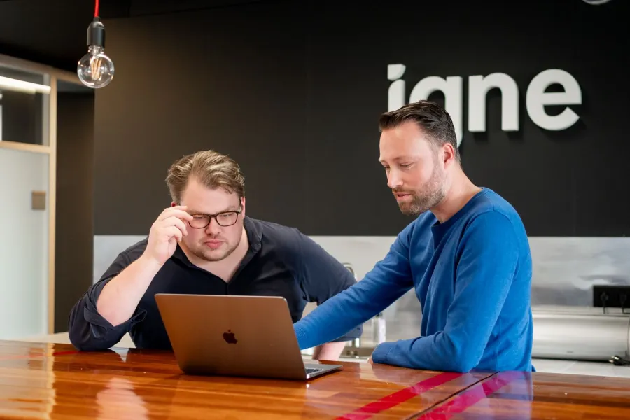 Two men looking at a laptop