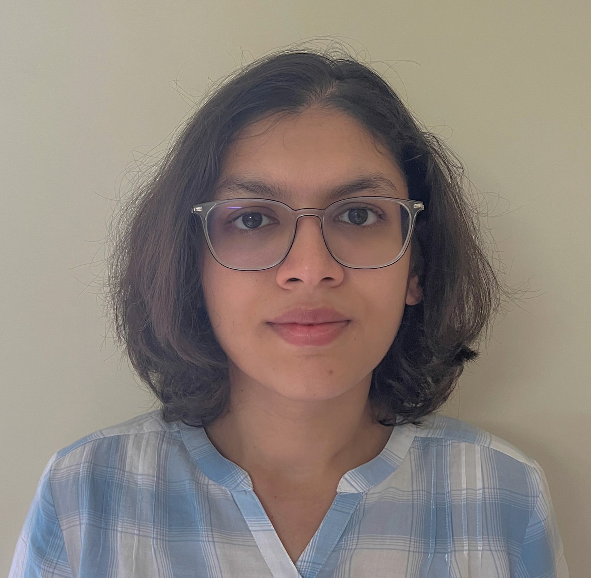 headshot of woman with glasses looking at the camera