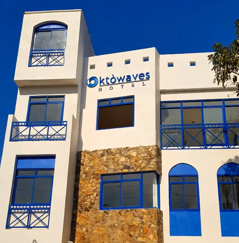 Oktowaves Hotel exterior with white walls, blue accents and outdoor pool in Brgy. Bucana, Nasugbu