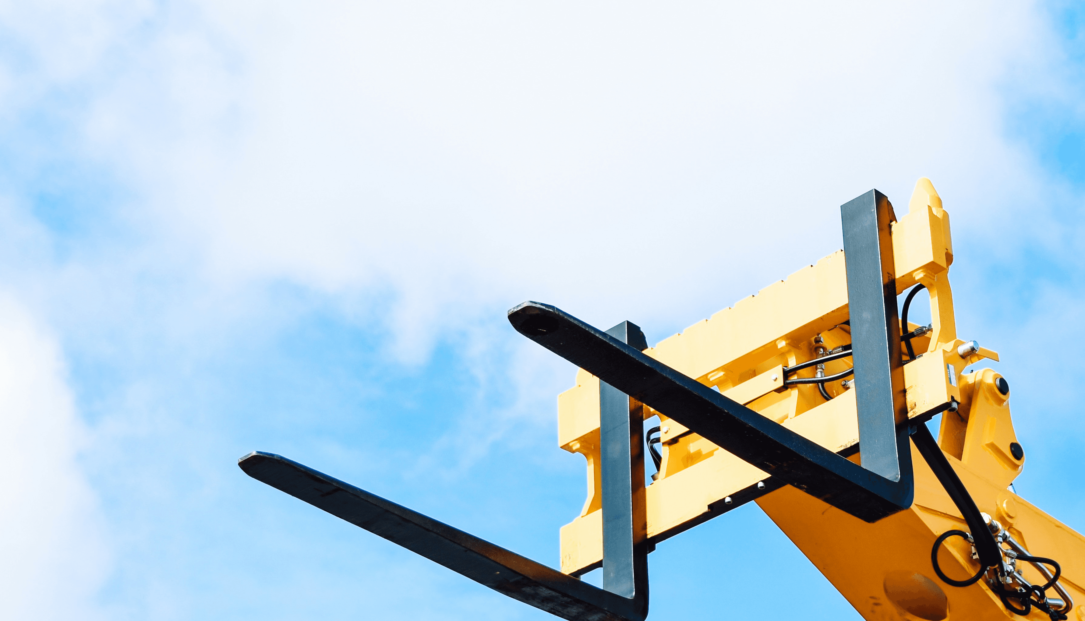 yellow and black crane under white clouds and blue sky during daytime