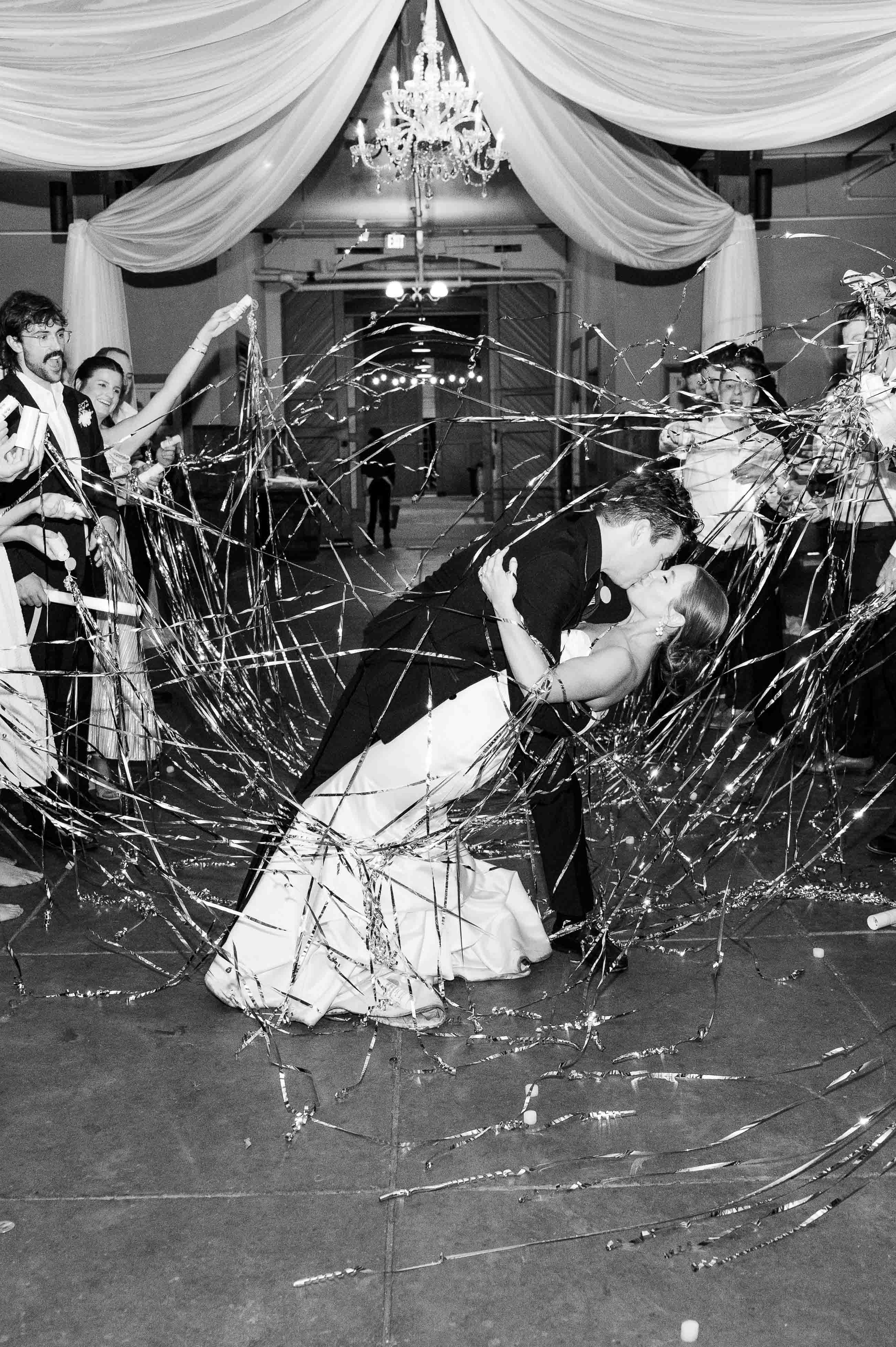 Black and white image of bride and groom's streamer exit at the Belle Meade Historic Site and Winery.