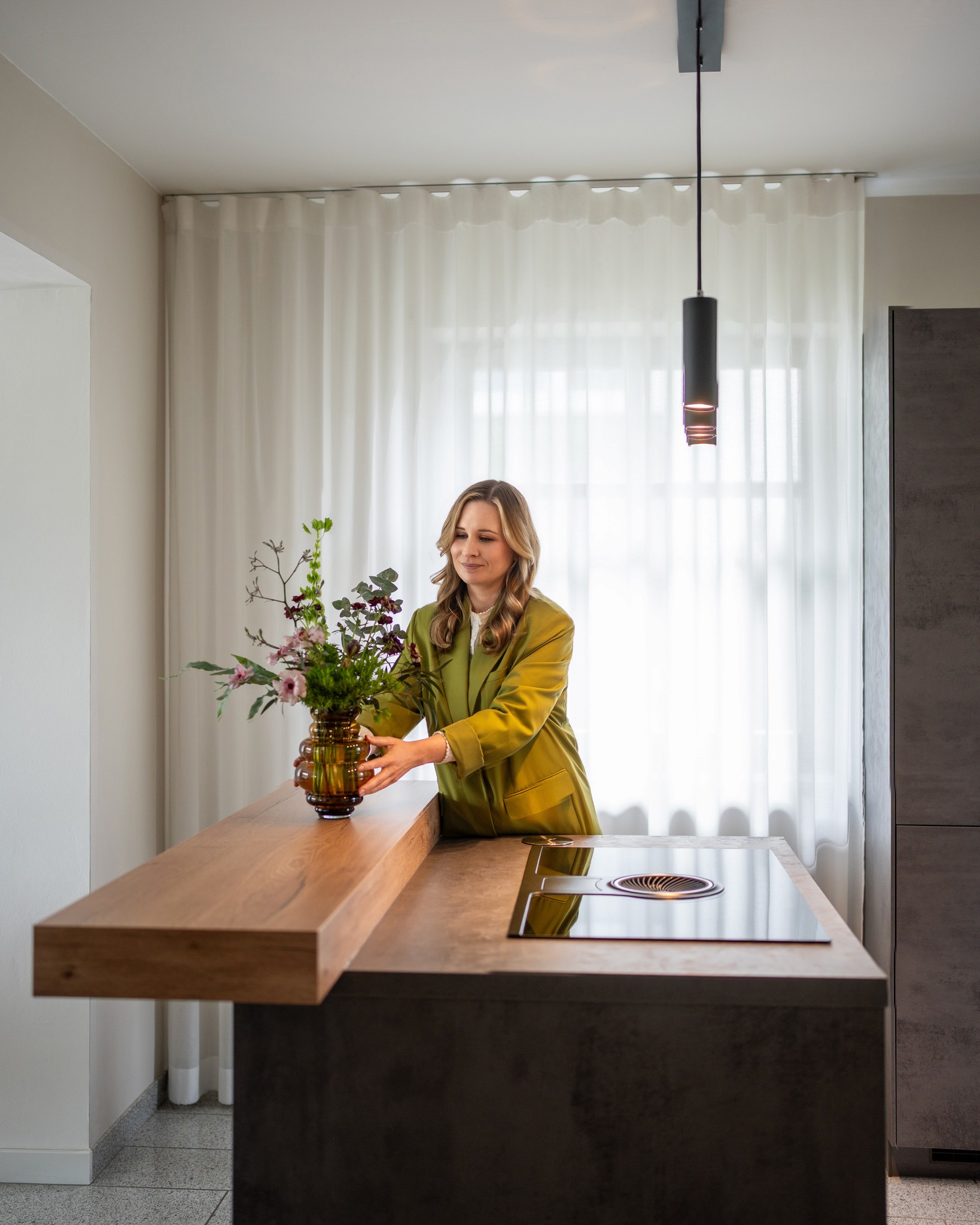 Eine Dame arrangiert die Blume in eine moderne Küche