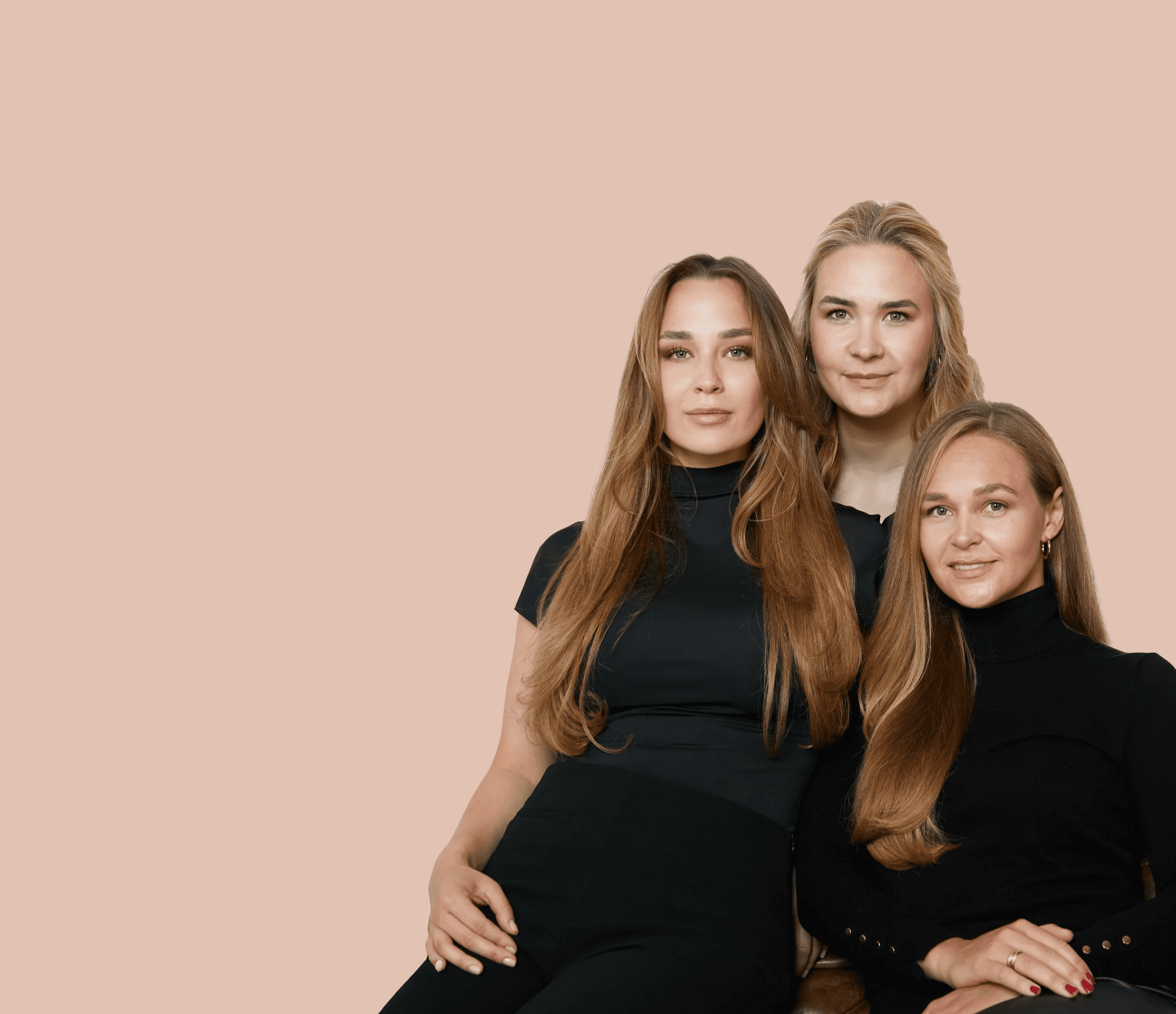 Close-up portrait of a woman with long red hair, closed eyes, and a soft expression, against a beige background