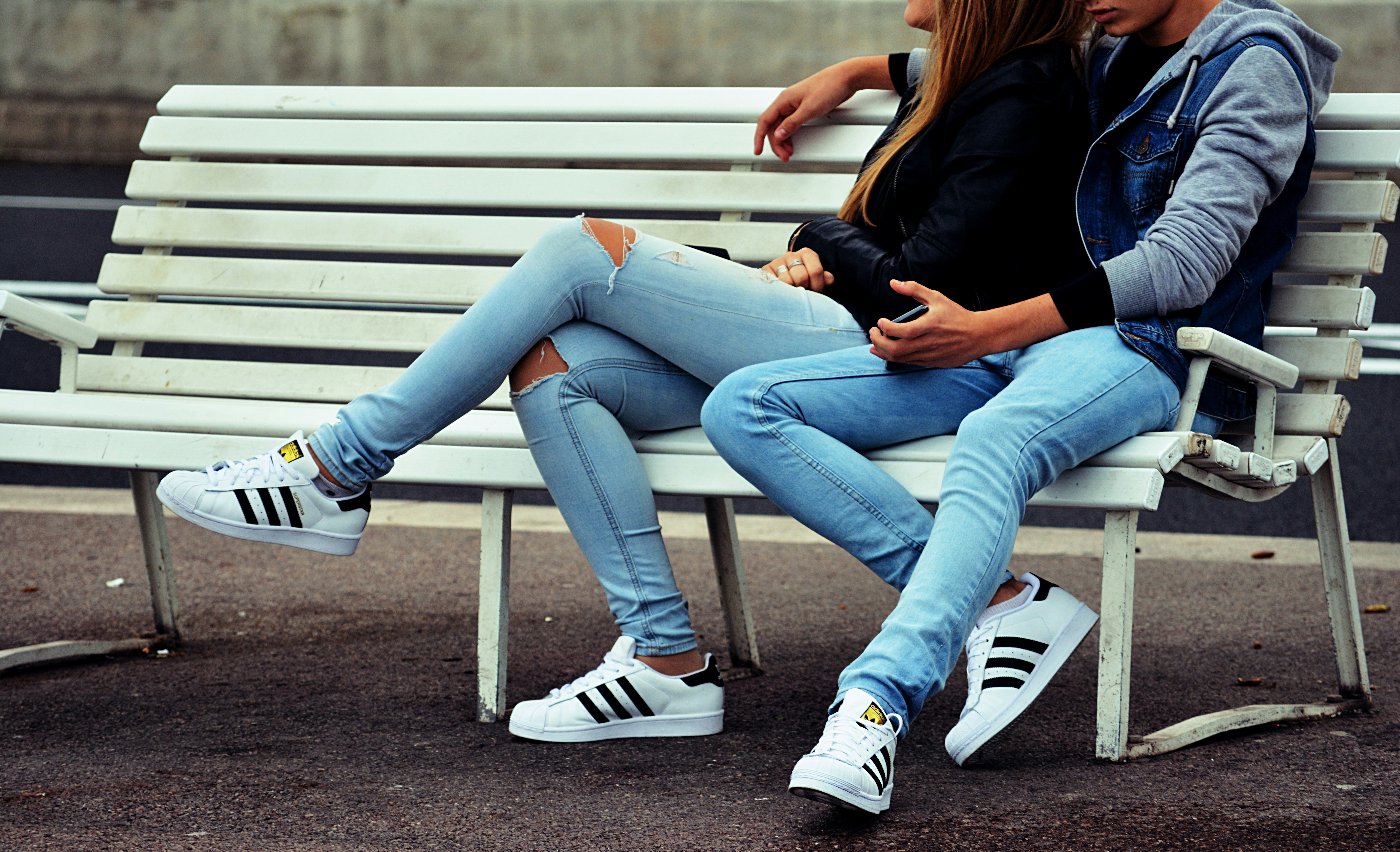 couple sitting on bench - Fall Couple Outfits