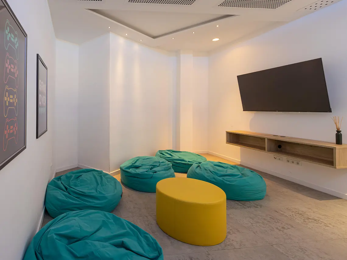 games-room.webp Media and games room in student accommodation in Münster with bean bags, large TV and lounge space