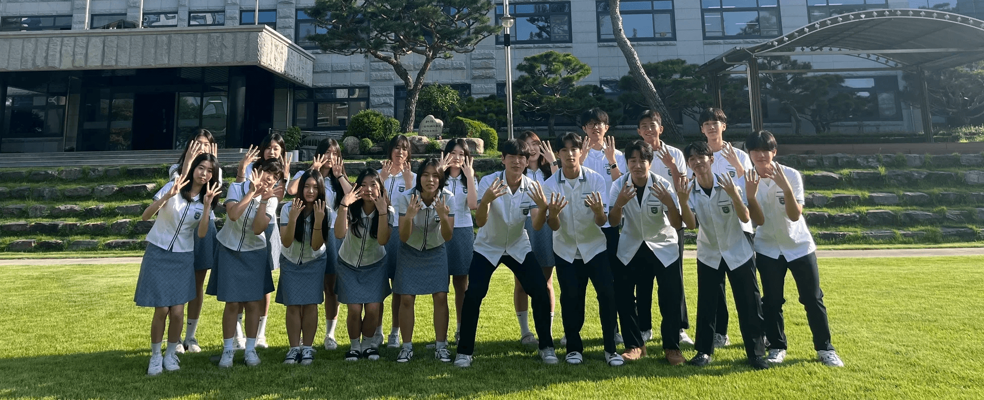 A group of people walking down a sidewalk