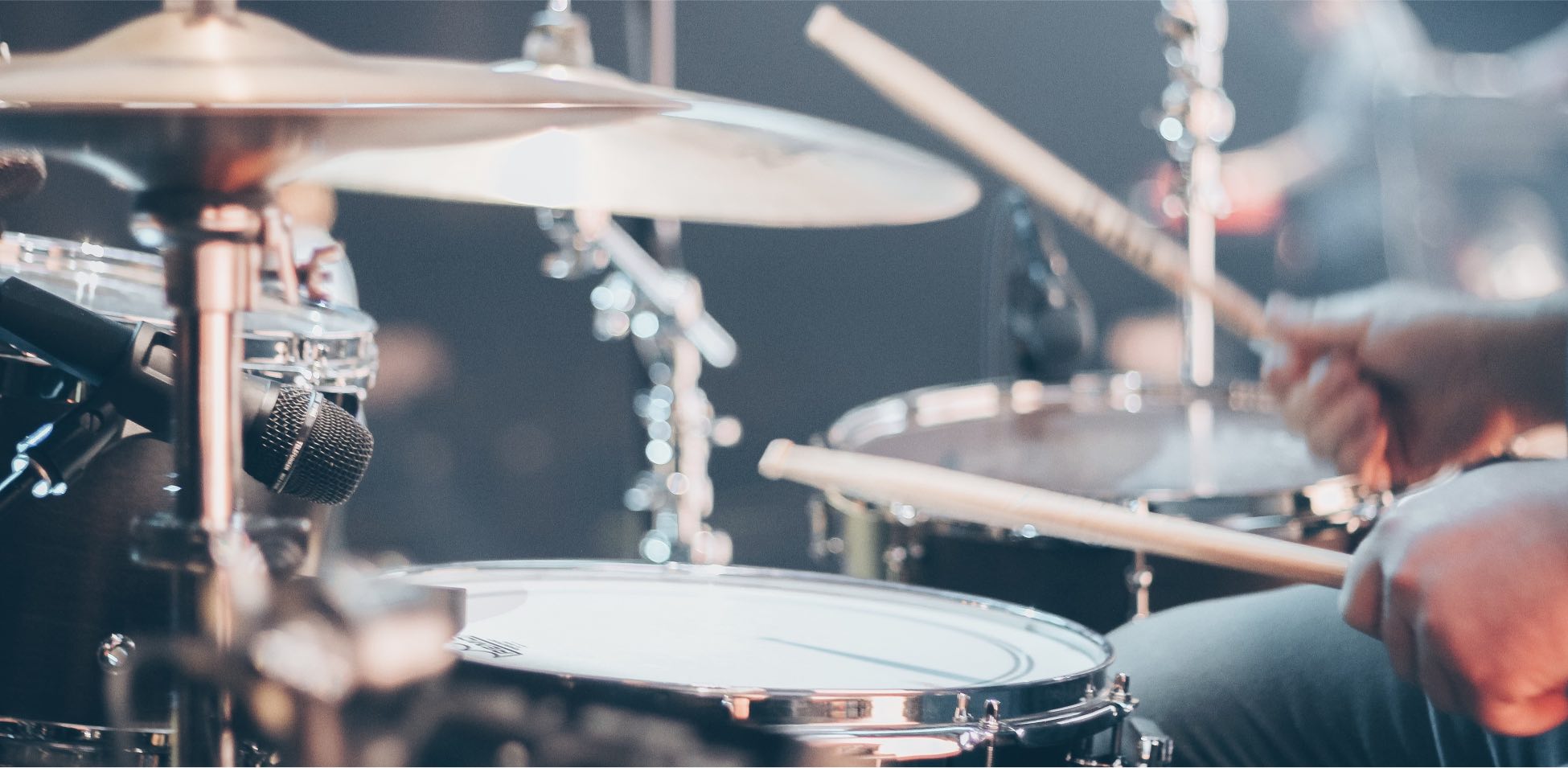 Person playing drums with a drumpipe.