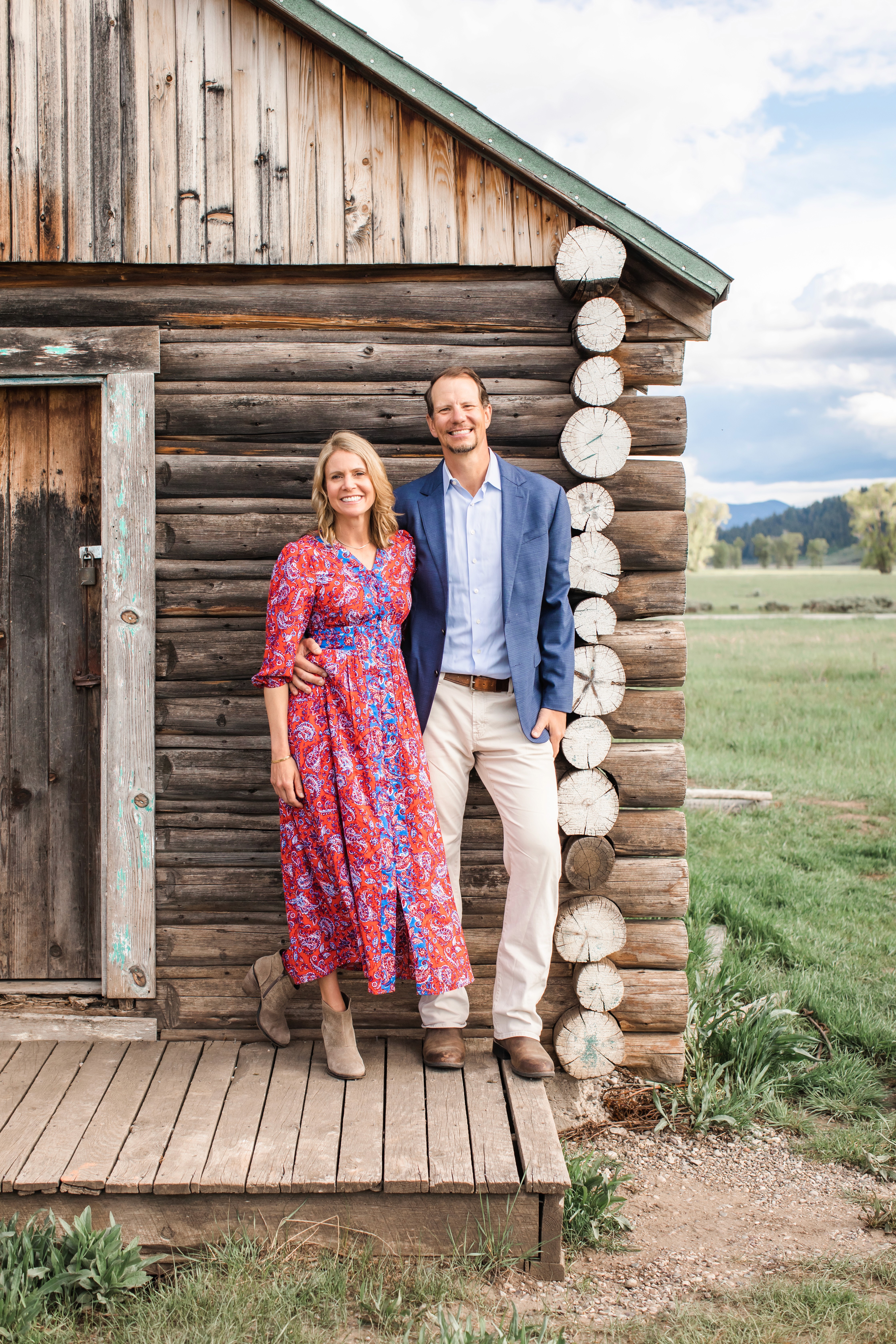 The Lusins standing outside mountain cabin in Jackson Hole representing personal wealth management approach