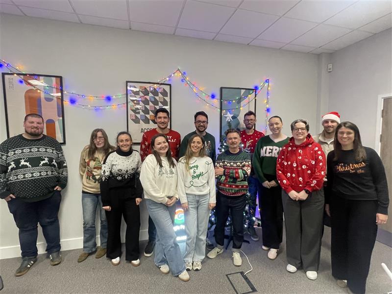 Presentation taking place in a conference room with a large screen displaying a KitKatslide.