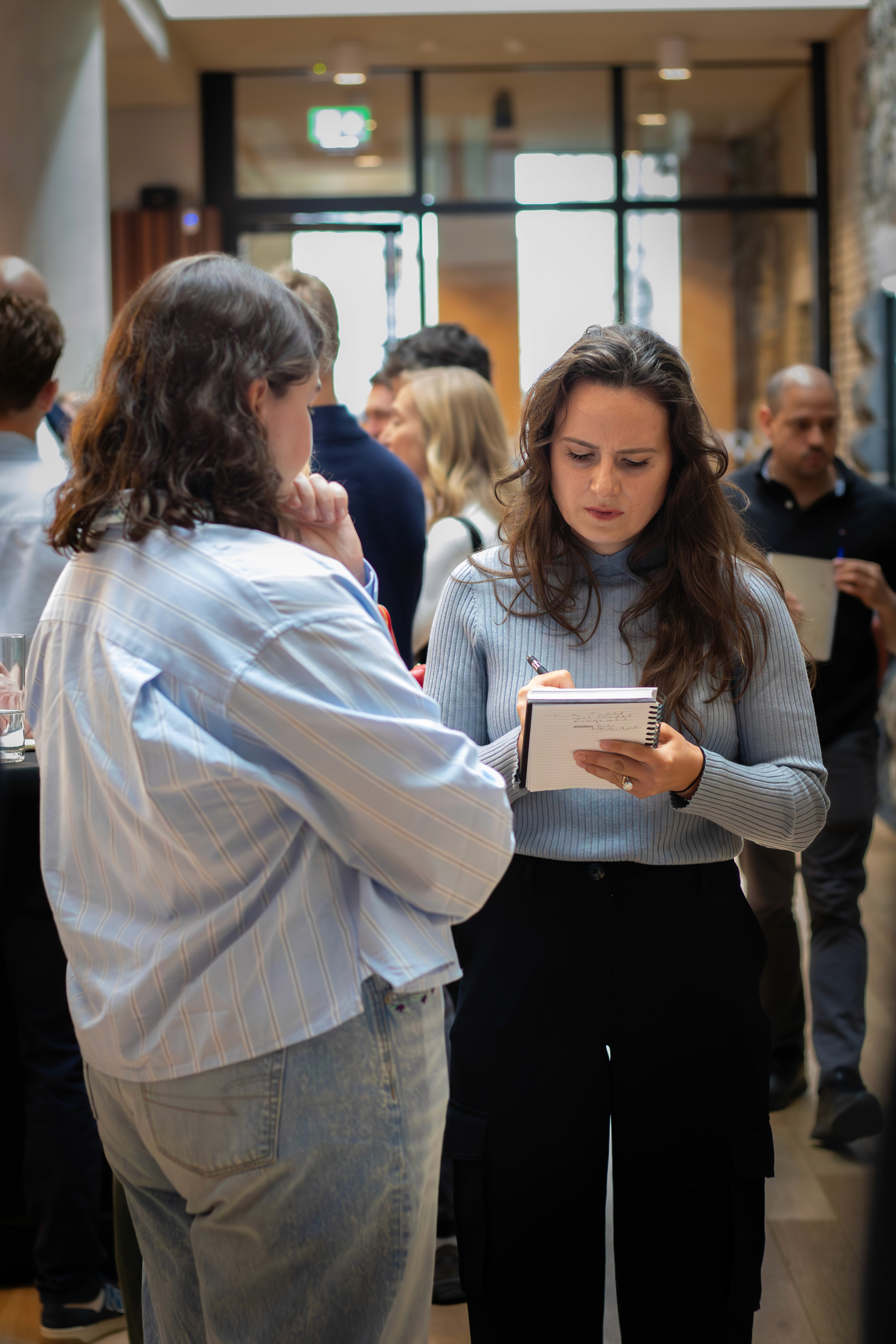 A bottle of Irish whiskey sits alongside a smartphone displaying a stock chart and an "Invest in Yourself" notebook with the MyWallSt logo, representing the diverse topics covered at Investicon: whiskey, stocks, and personal financial growth. Join us at the Irish Stock Exchange. #Investicon #WhiskeyInvesting #StockInvesting #MyWallSt #InvestInYourself #FinancialConference #Dublin