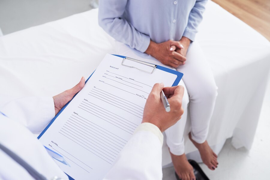 A doctor filling form for the patient.