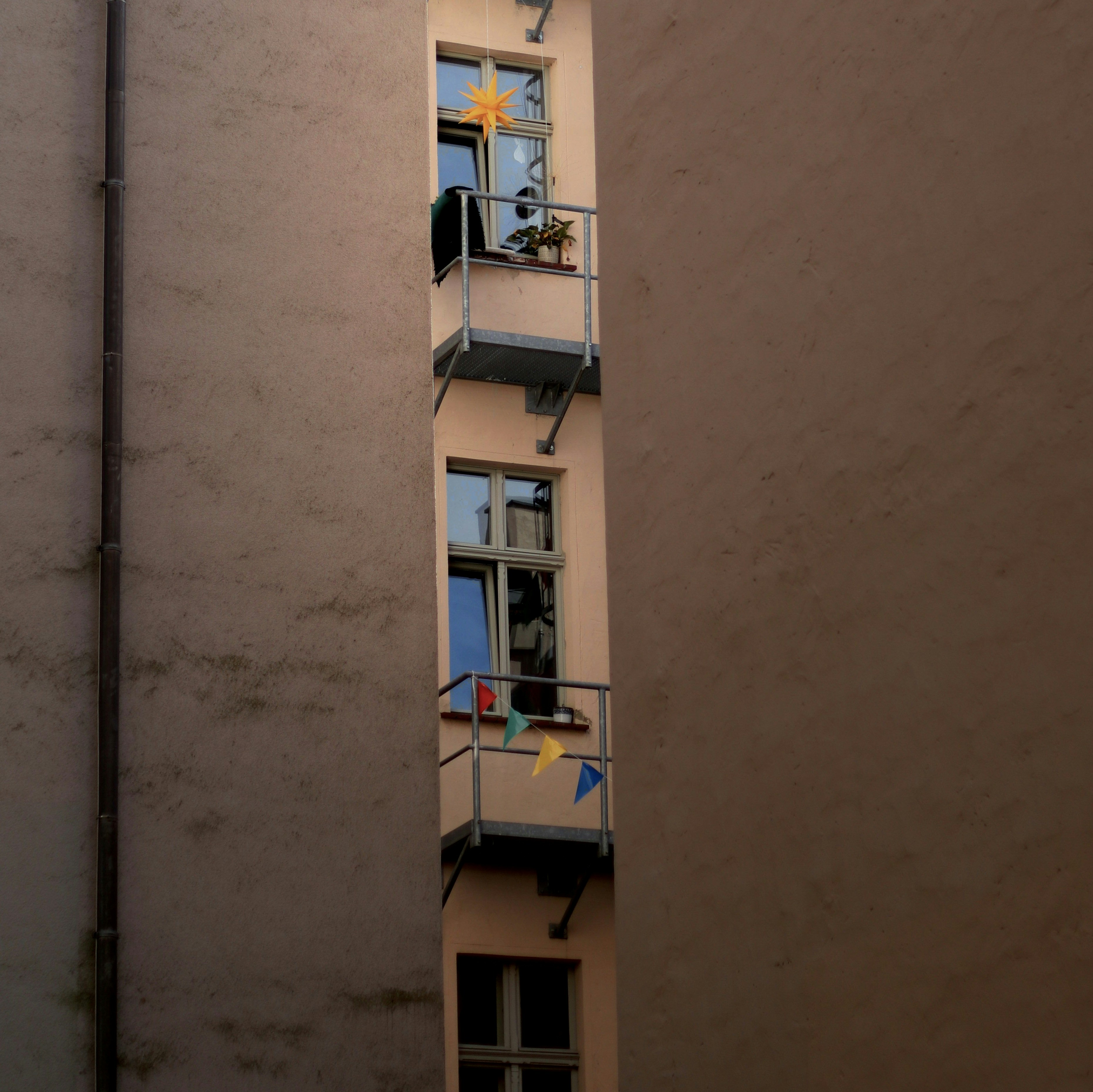 a tall building with a couple of balconies on top of it