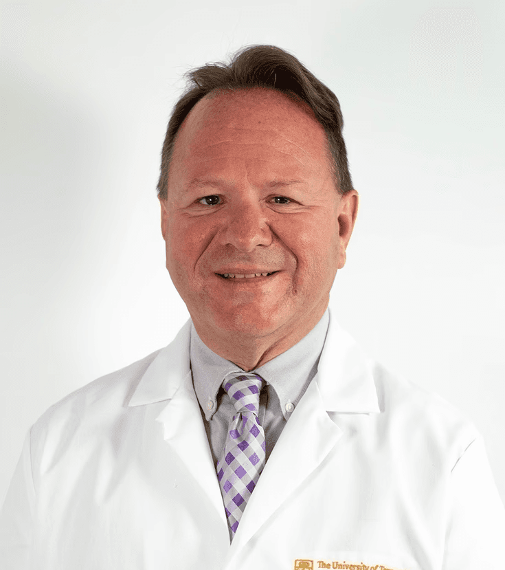 Jeff Newport MD professional photo in a white medical coat with striped purple tie