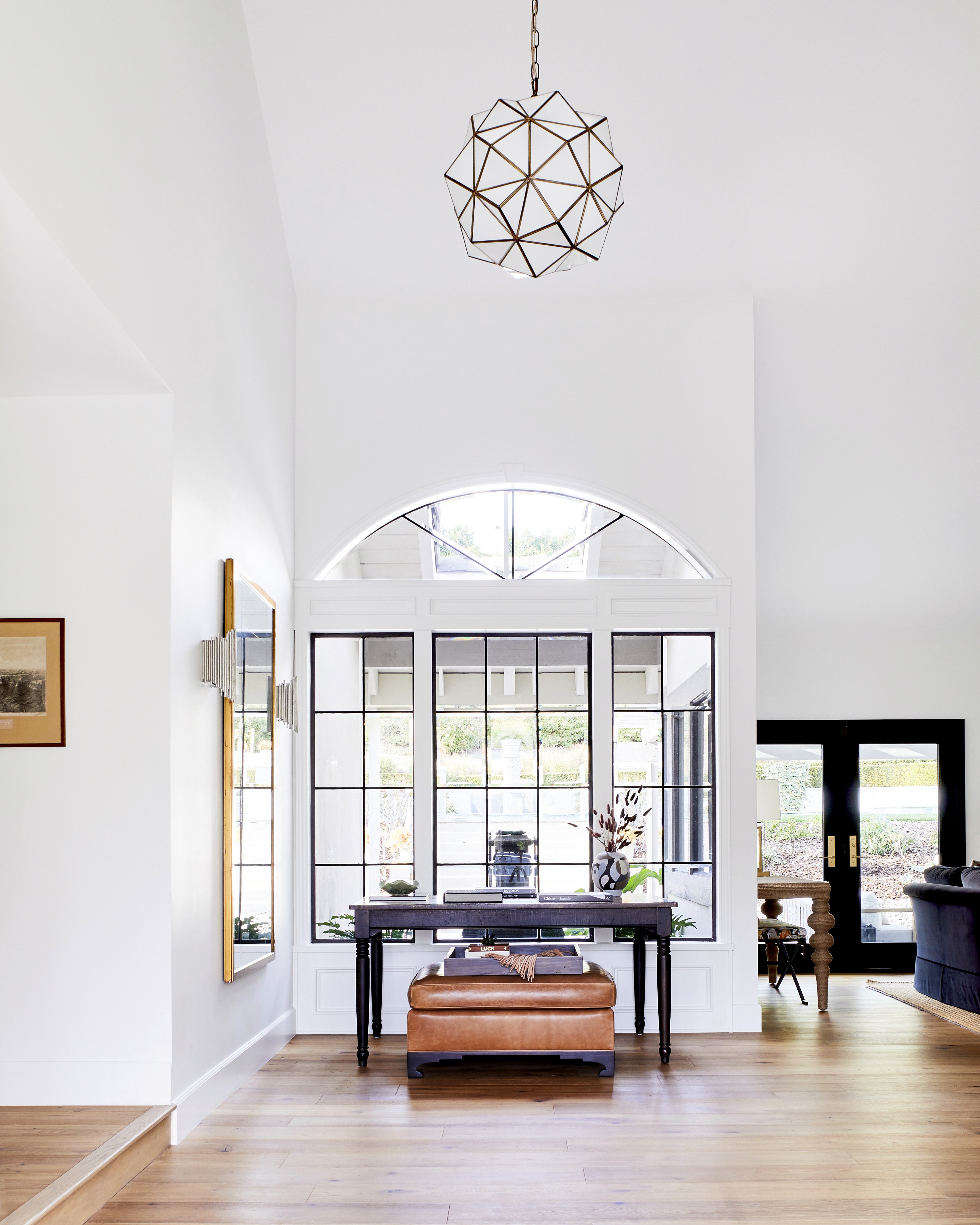 This contemporary living room features a cozy, airy atmosphere with a custom linen sofa and earthy wooden accents
