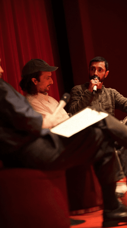 Bride and groom walking on street at night