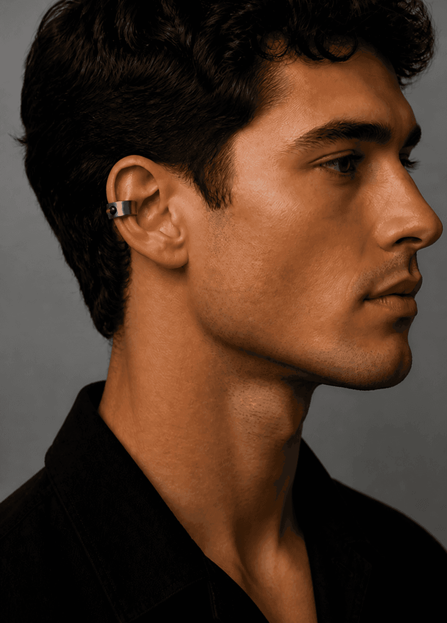 Man wearing the Mote titanium ear cuff, seen from behind