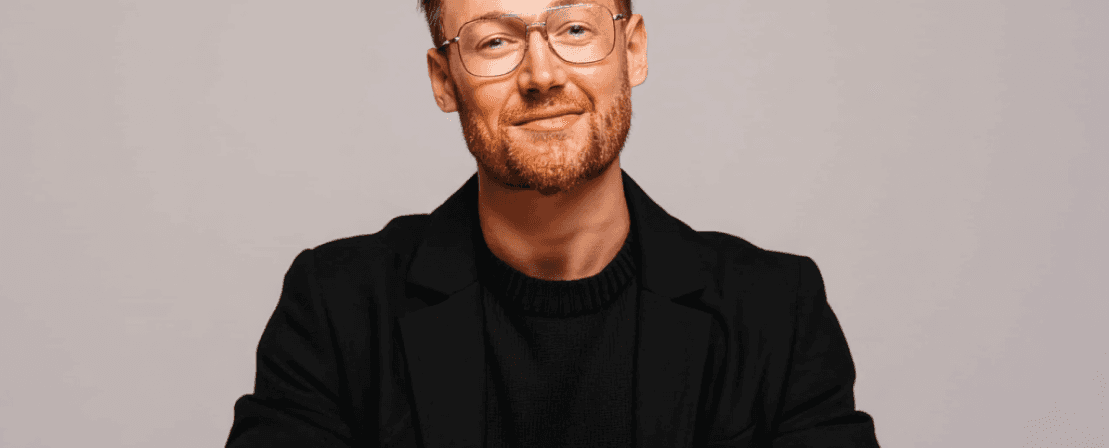 Visual designer in a minimalist studio with an iPad