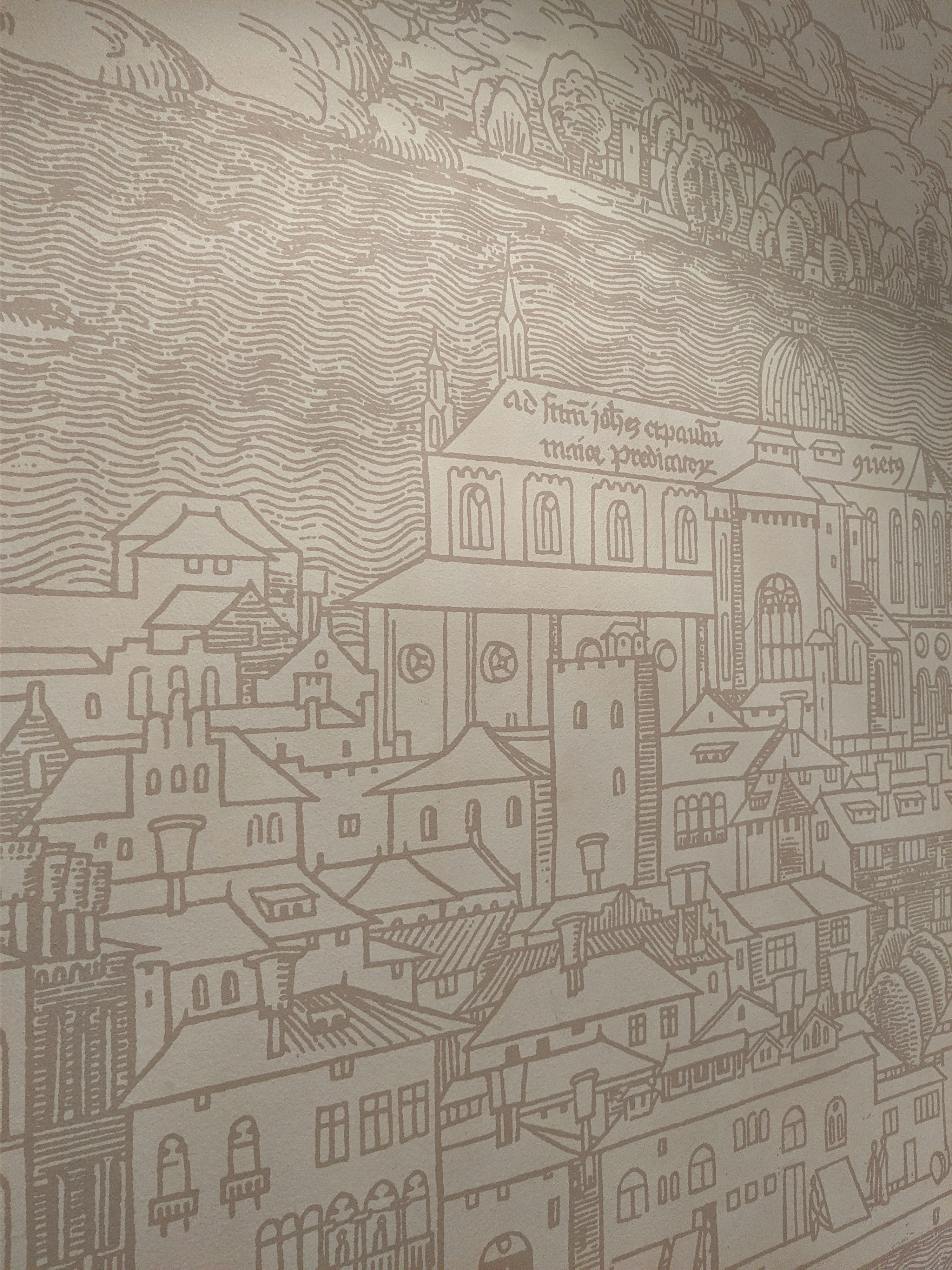 a wall with a drawing of a city on it