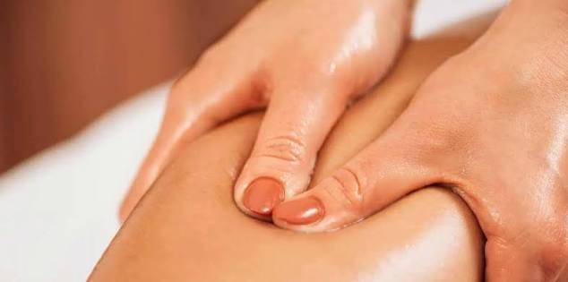 Detail view of hands-on, deep tissue therapeutic massage being performed to relieve shoulder and neck tension at.