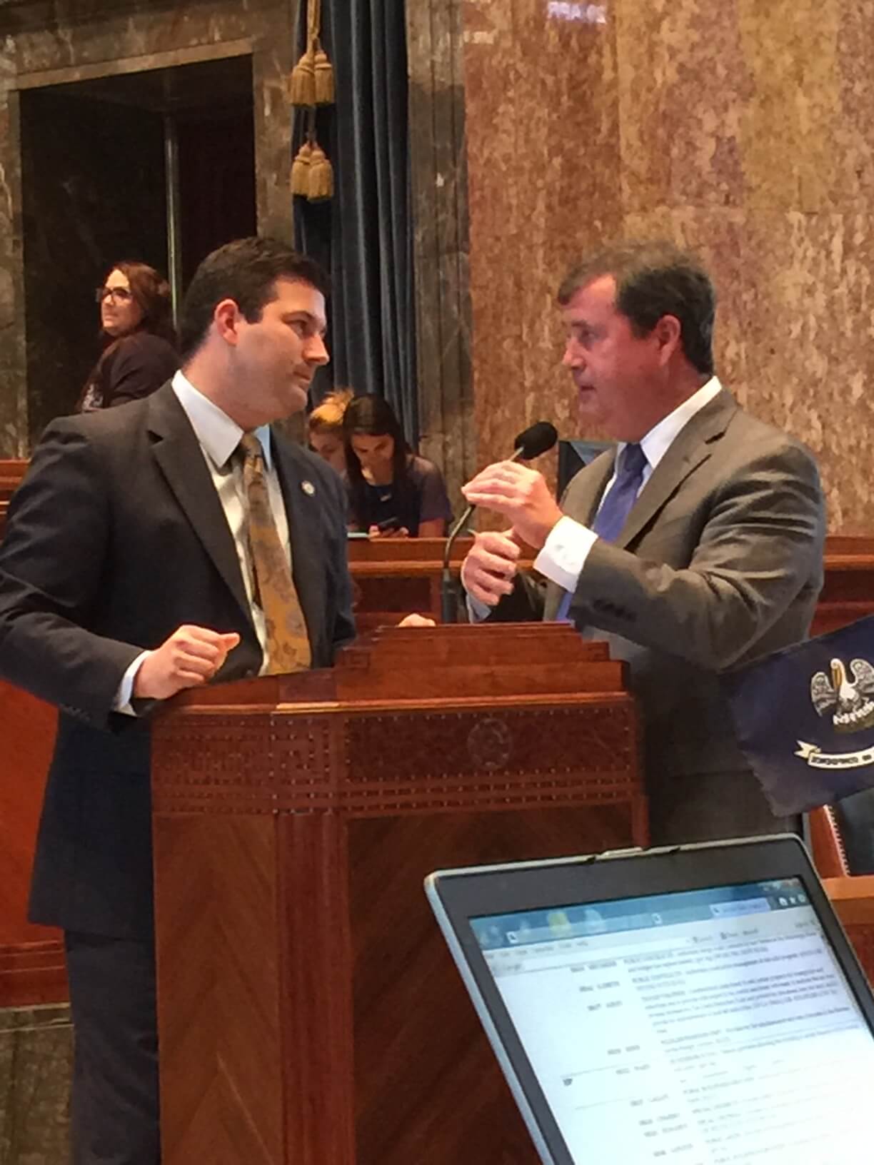 Rick ward Speaking with a man by a podium