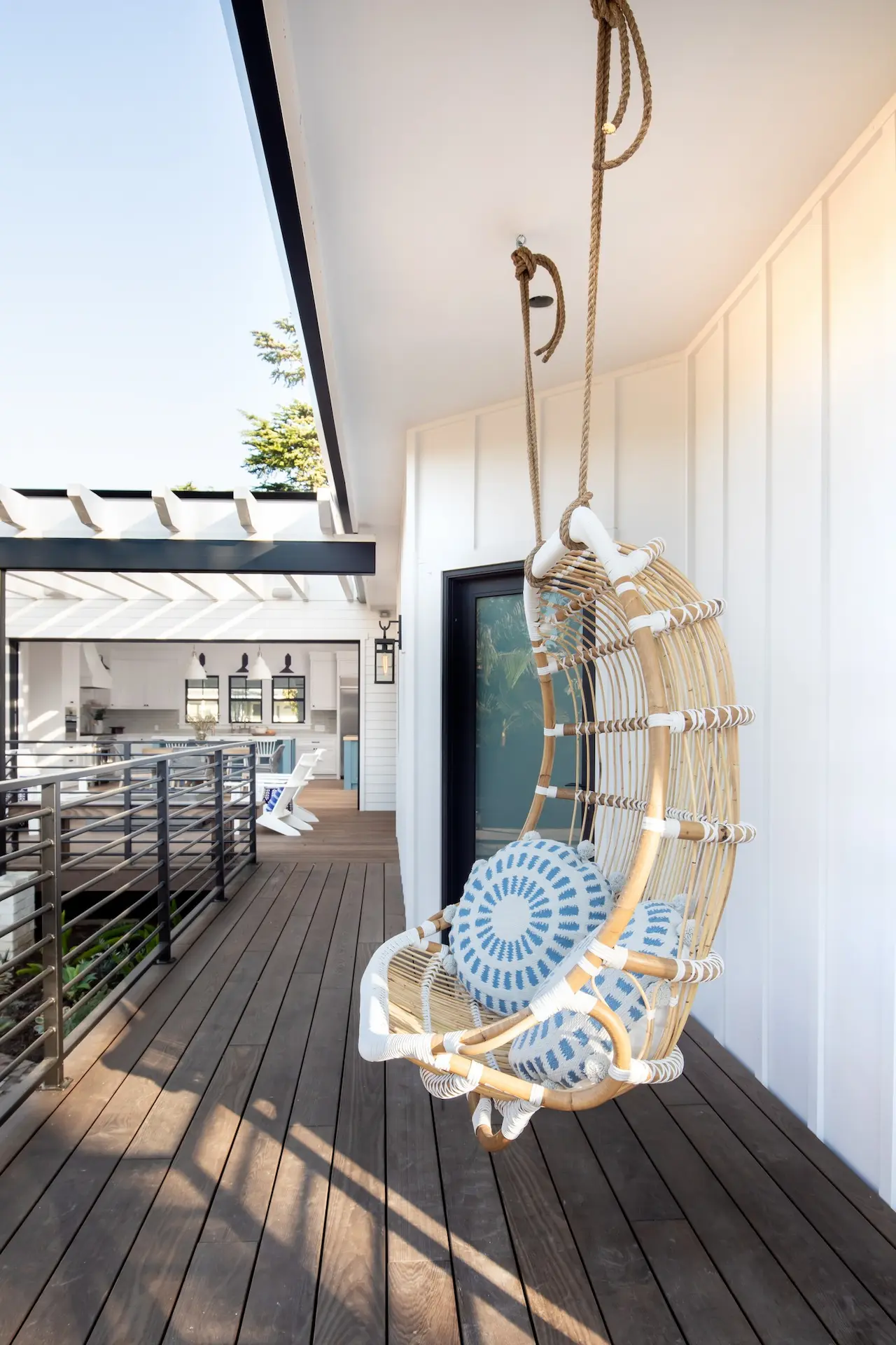 Hanging wicker chair on a balcony in North Tustin Remodel & Addition. Photo by Molly Rose.
