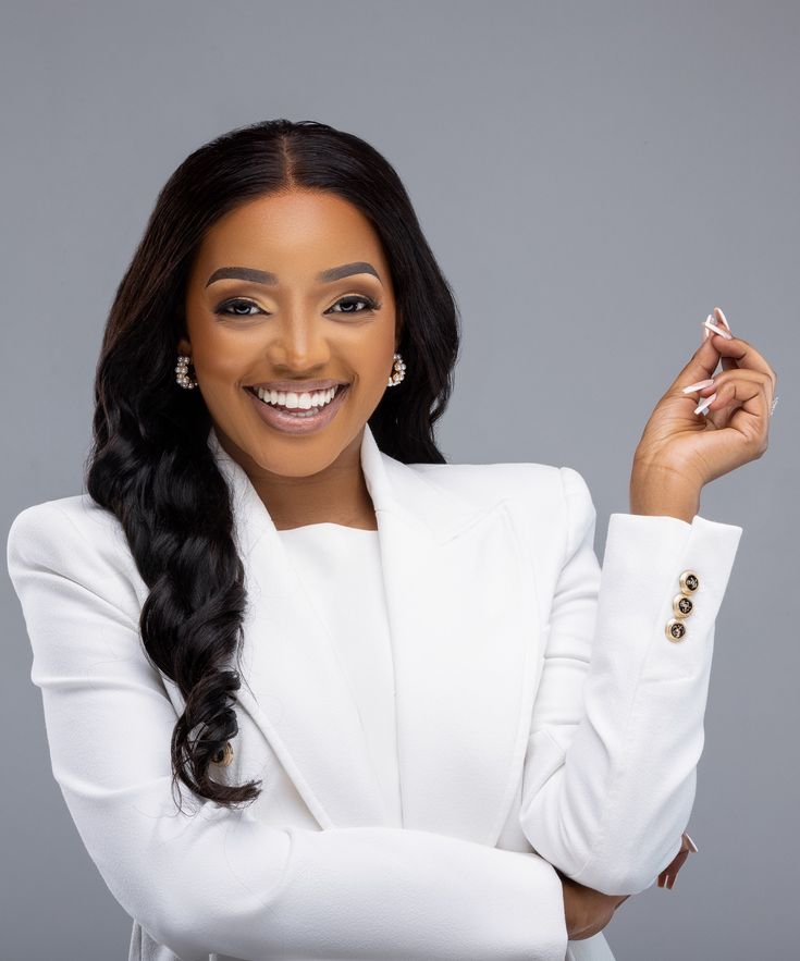 smiling woman wearing white and black pinstriped collared top