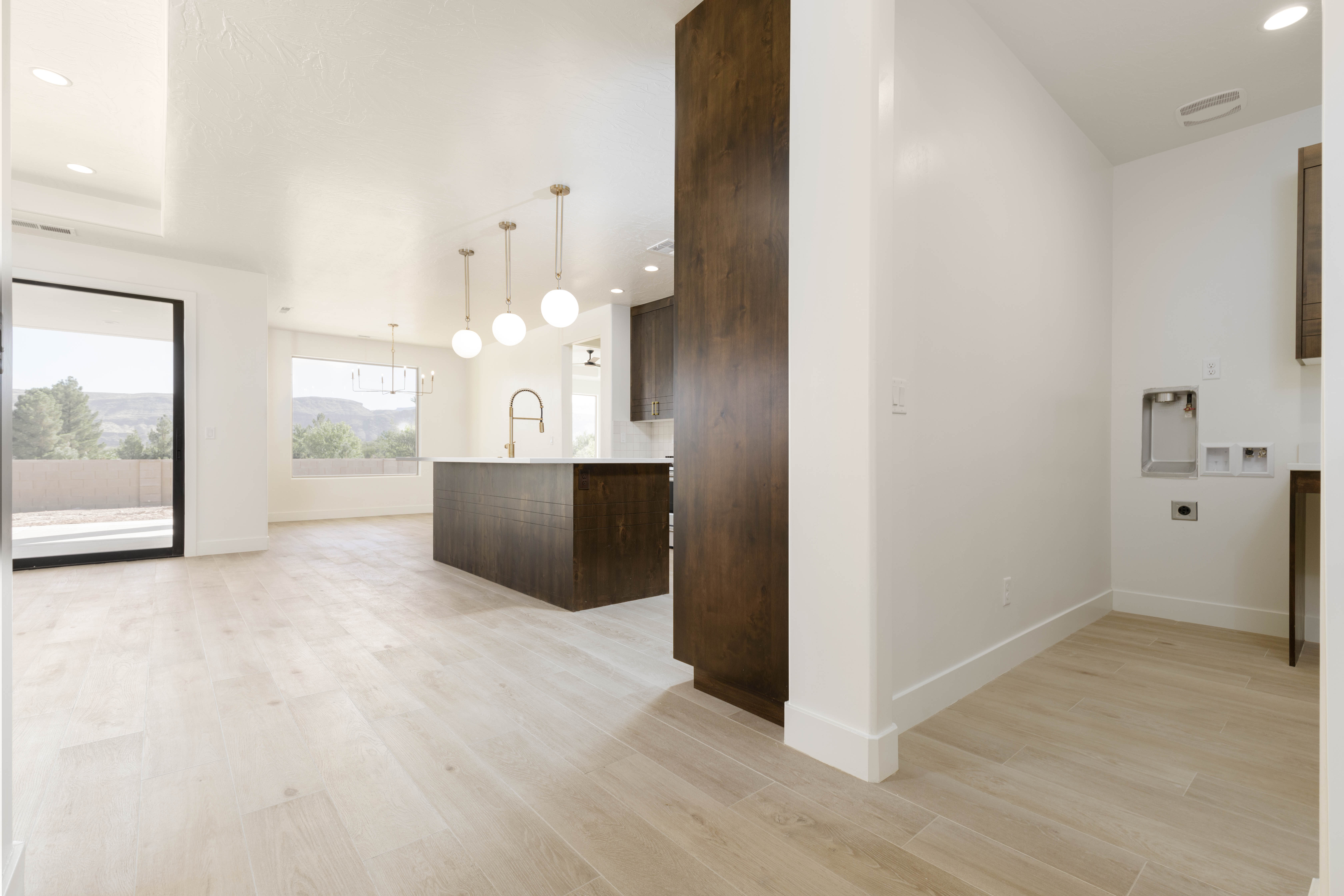 Functional laundry room and kitchen in new construction home in Hurricane Utah.