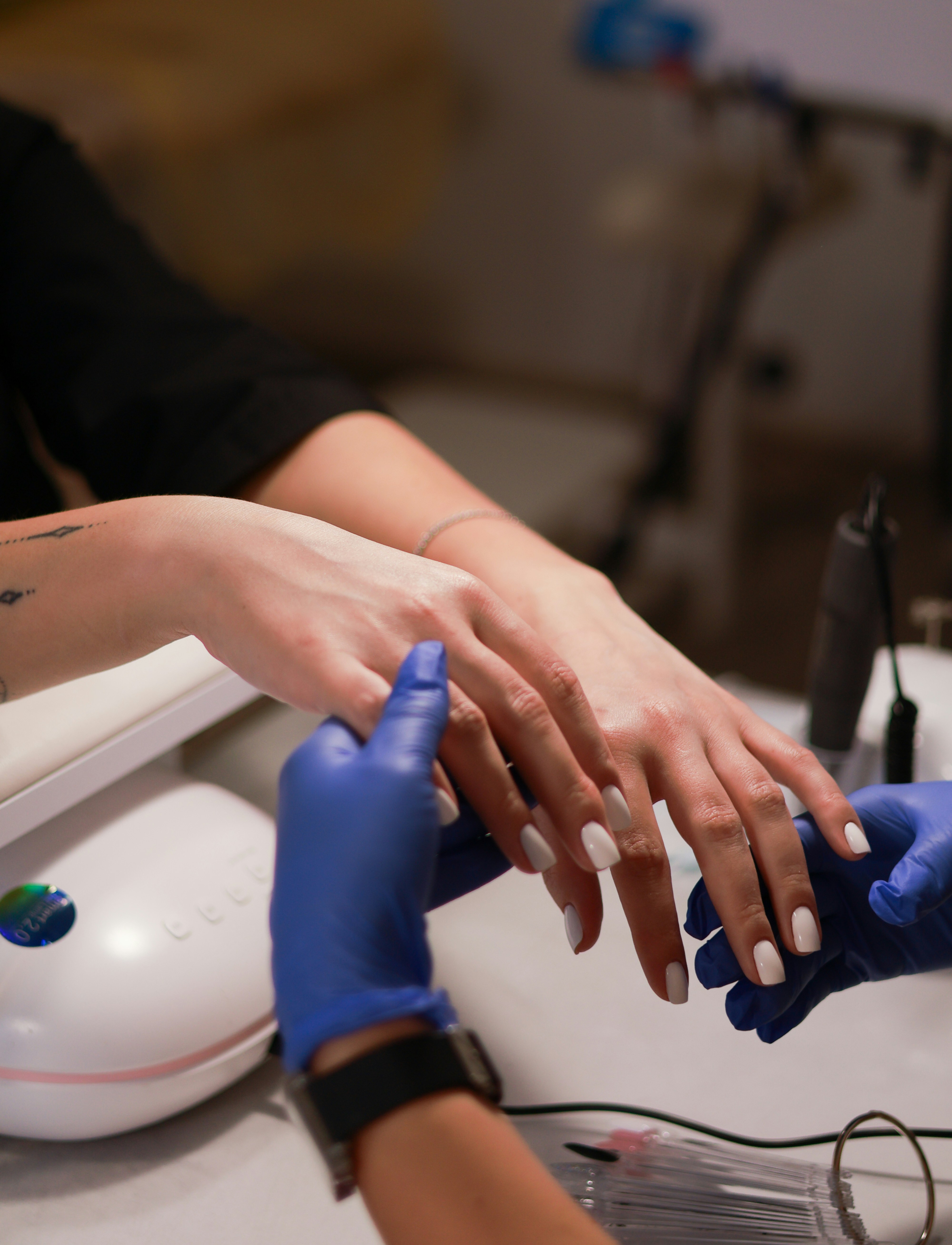 a woman getting her nails done at a salon