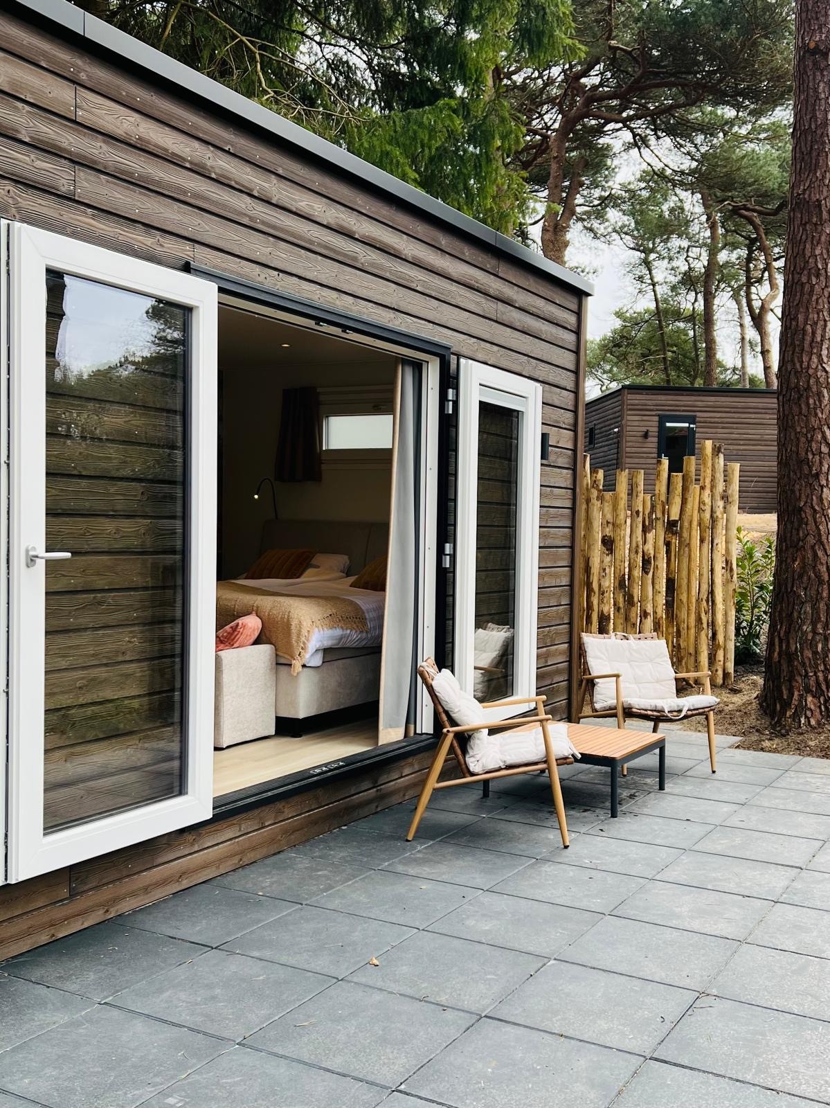 a wooden walkway between two buildings with windows