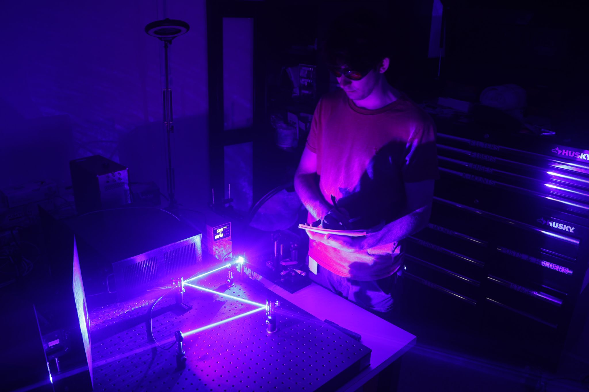 Star Catcher engineer working on lasers in a lab