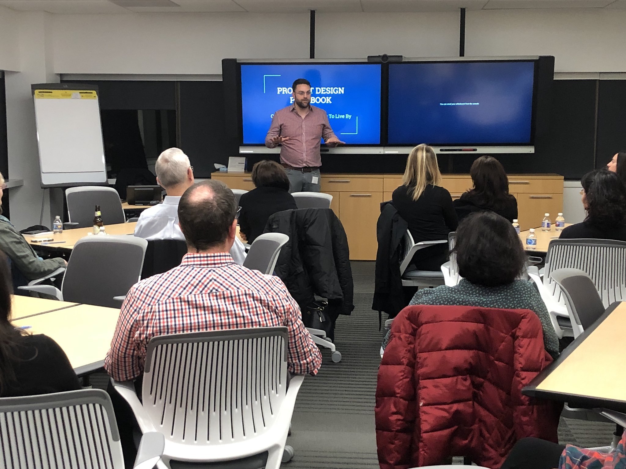 Matthew Voshell speaking in front of an audience in a classroom setting.