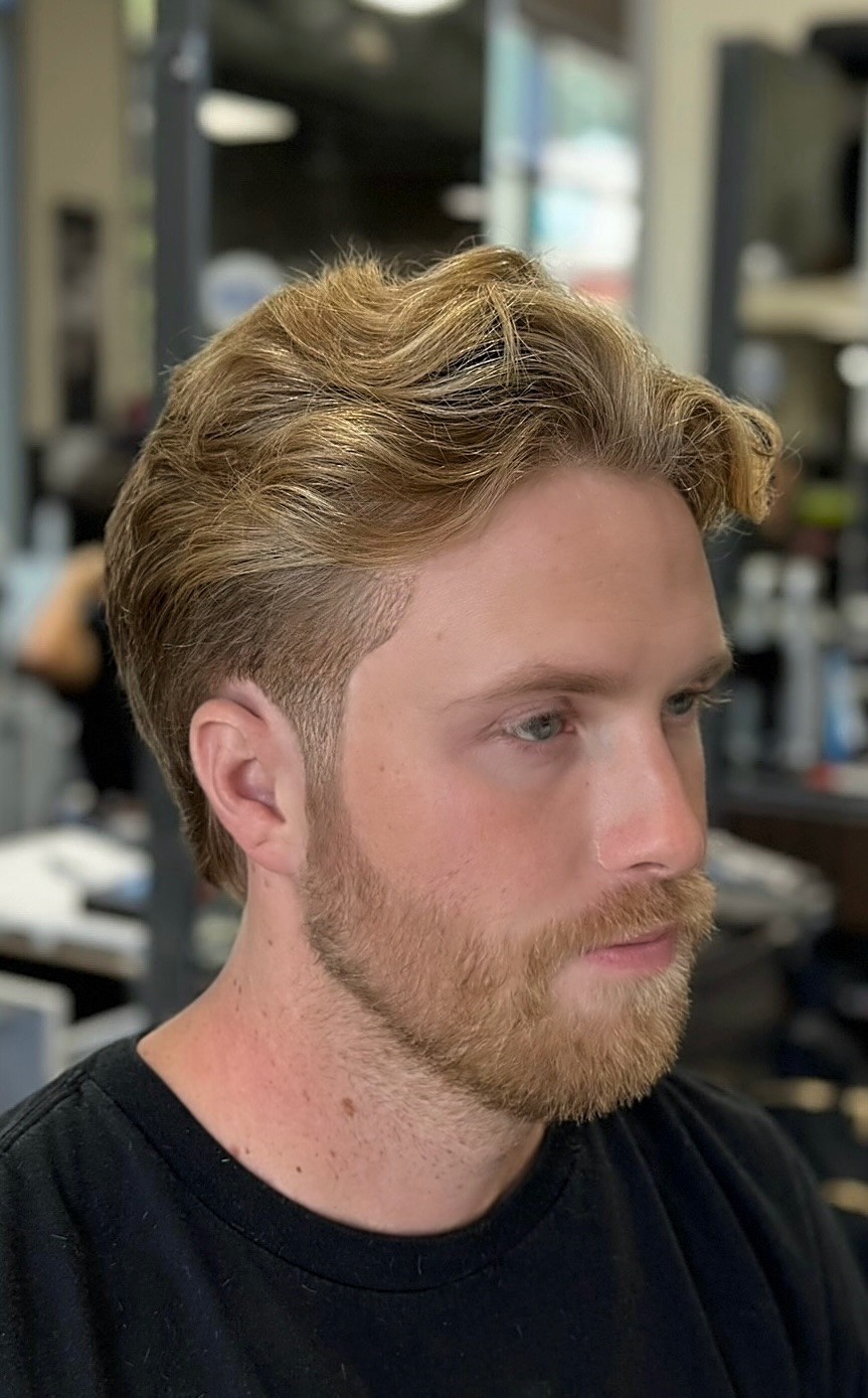 Gentlemen’s haircut featuring blond highlights and a polished finish by Courtney Palmore, perfect for upscale men’s styling.