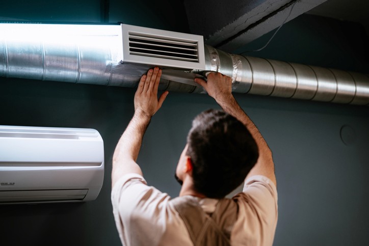 HVAC specialist cleaning residential ductwork in Mississauga to remove dust, debris, and improve airflow for better indoor air quality.
