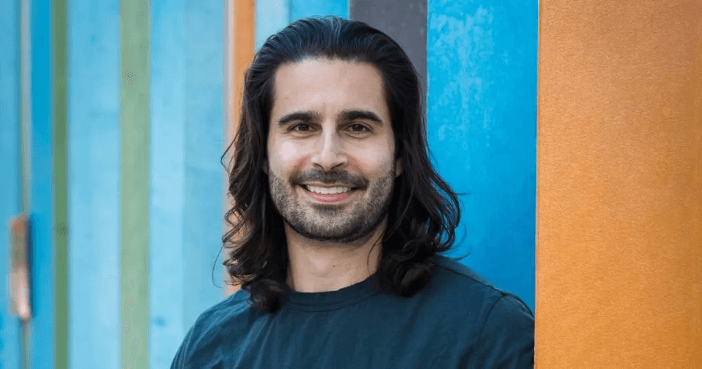 a blue and pink background with a circular object in the middle