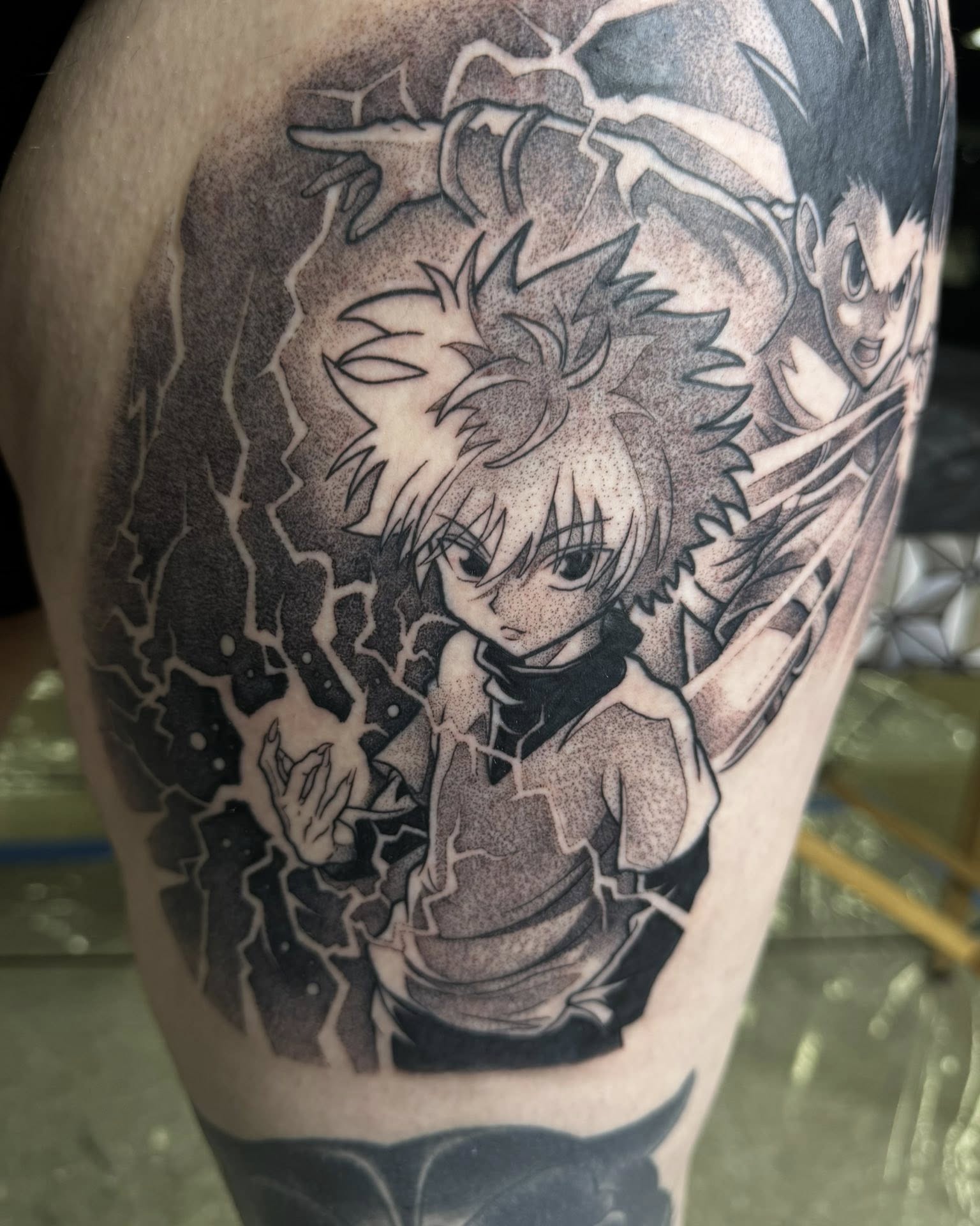 A forearm tattoo of Nezuko Kamado from Demon Slayer, depicted in a stylized anime art style. She is holding a sword.