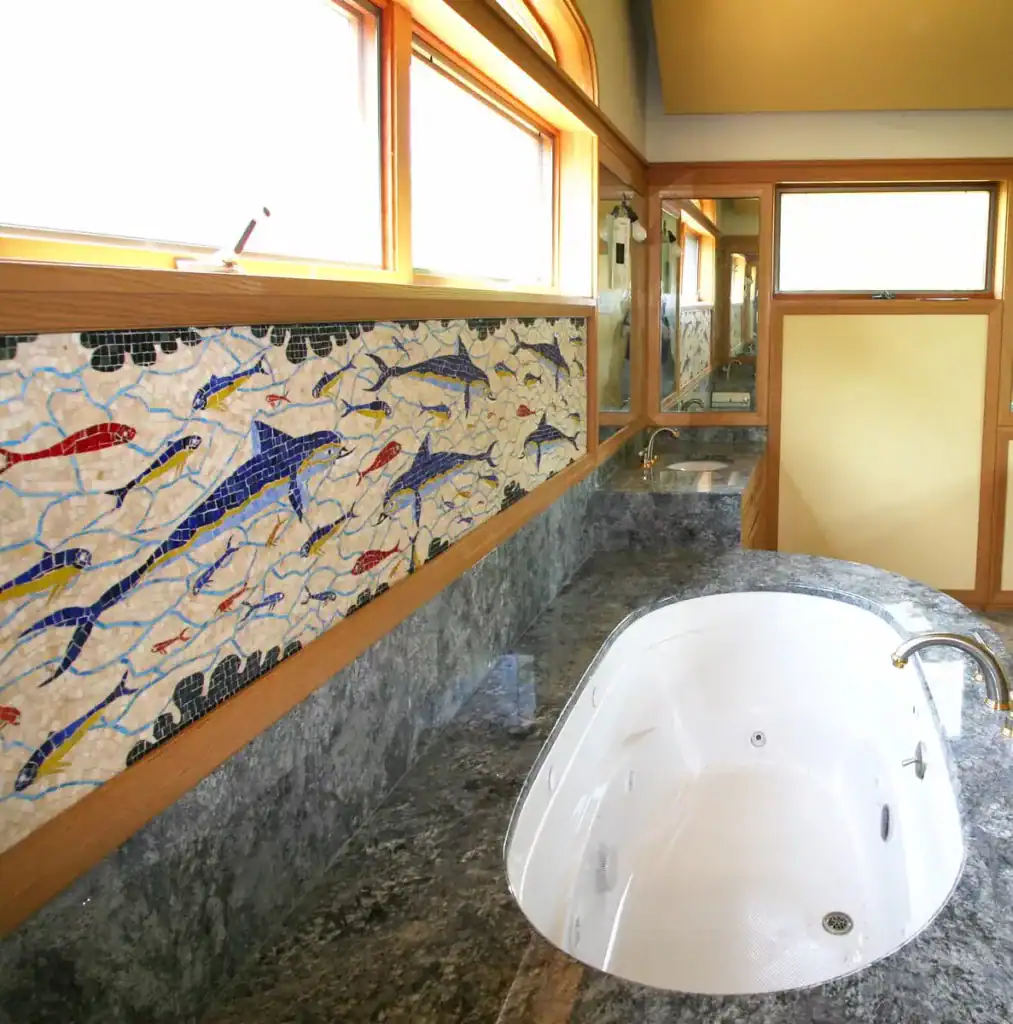 Fish mosaic wall art in Mosaic Legs Art Studio, showcasing vibrant aquatic designs.