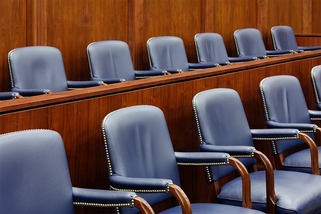 Empty jury box inside a courtroom, representing the trial process in defective and dangerous product liability cases