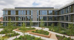 Sustainable urban architecture featuring a biophilic courtyard framed by glass façades and vertical gardens. Integrates natural landscaping, trees, and elevated planter beds — designed to enhance property ROI through eco-conscious design and community appeal.