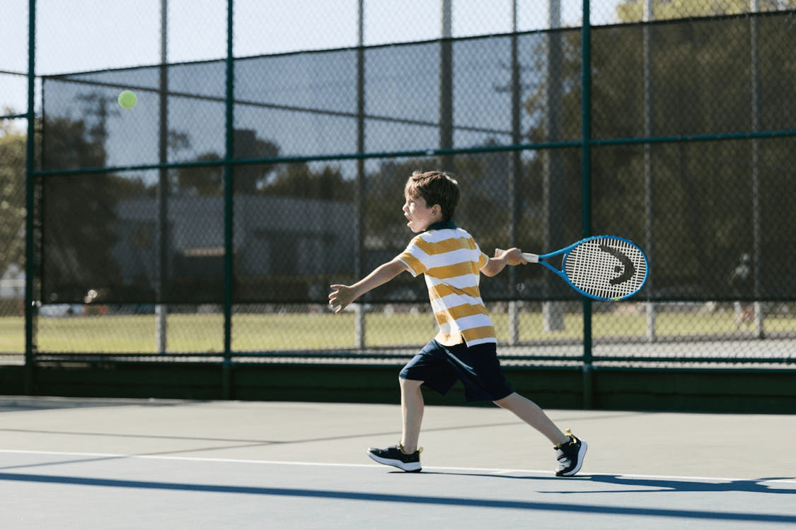 kid playing tennis