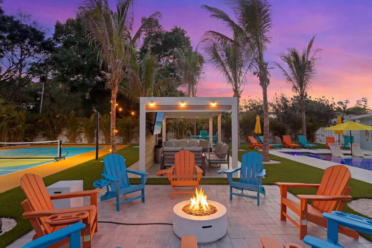 Fire pit with pergola at twilight at Private Backyard Resort, Bradenton, Florida