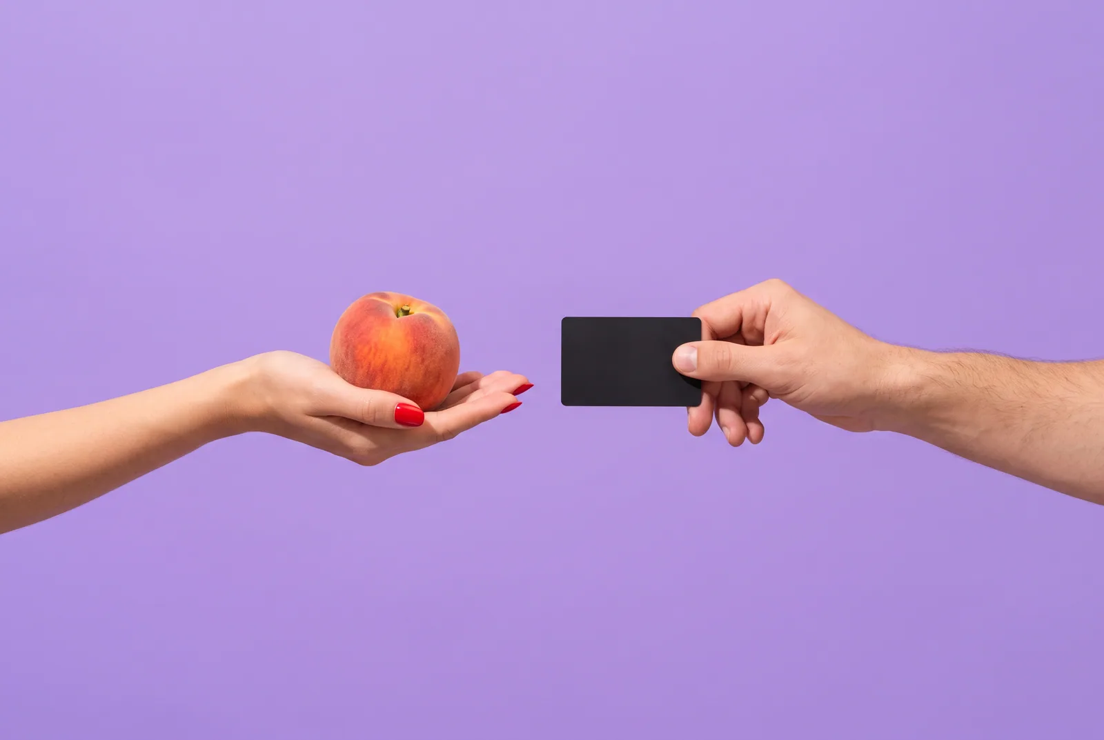 Parasocial relationship on OnlyFans concept: a single cherry facing a small hand mirror that reflects a pair of cherries on a lilac backdrop