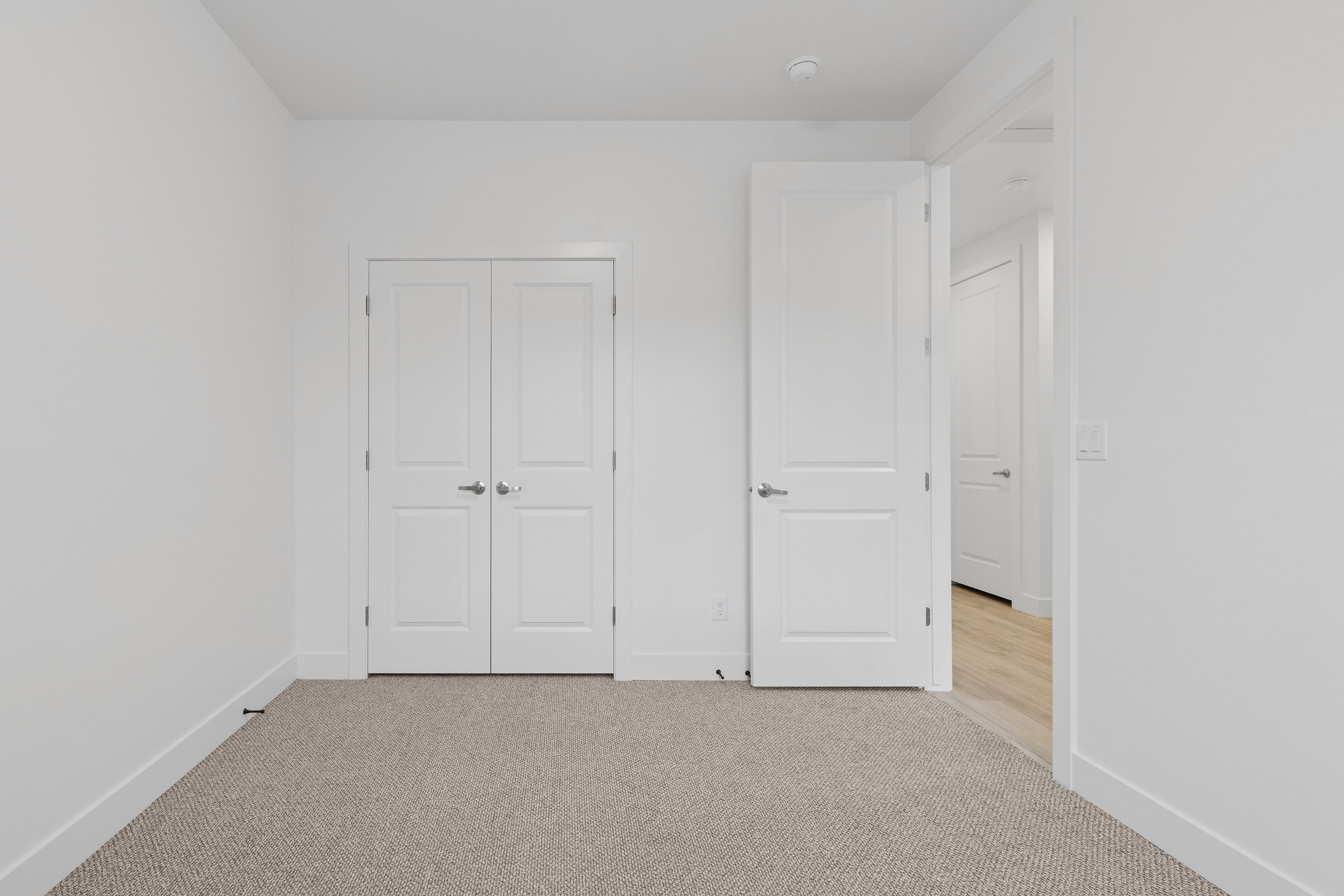 Secondary bedroom with closet and modern finishes in The High Desert Home in Hurricane Utah.